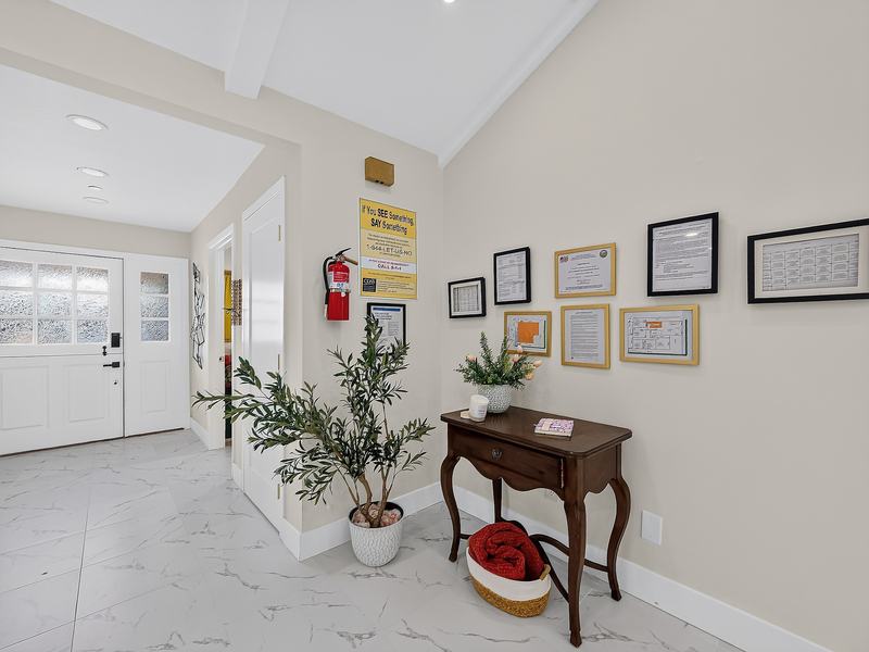 The entry by the front door, where the home's licenses and certificates are framed on the wall